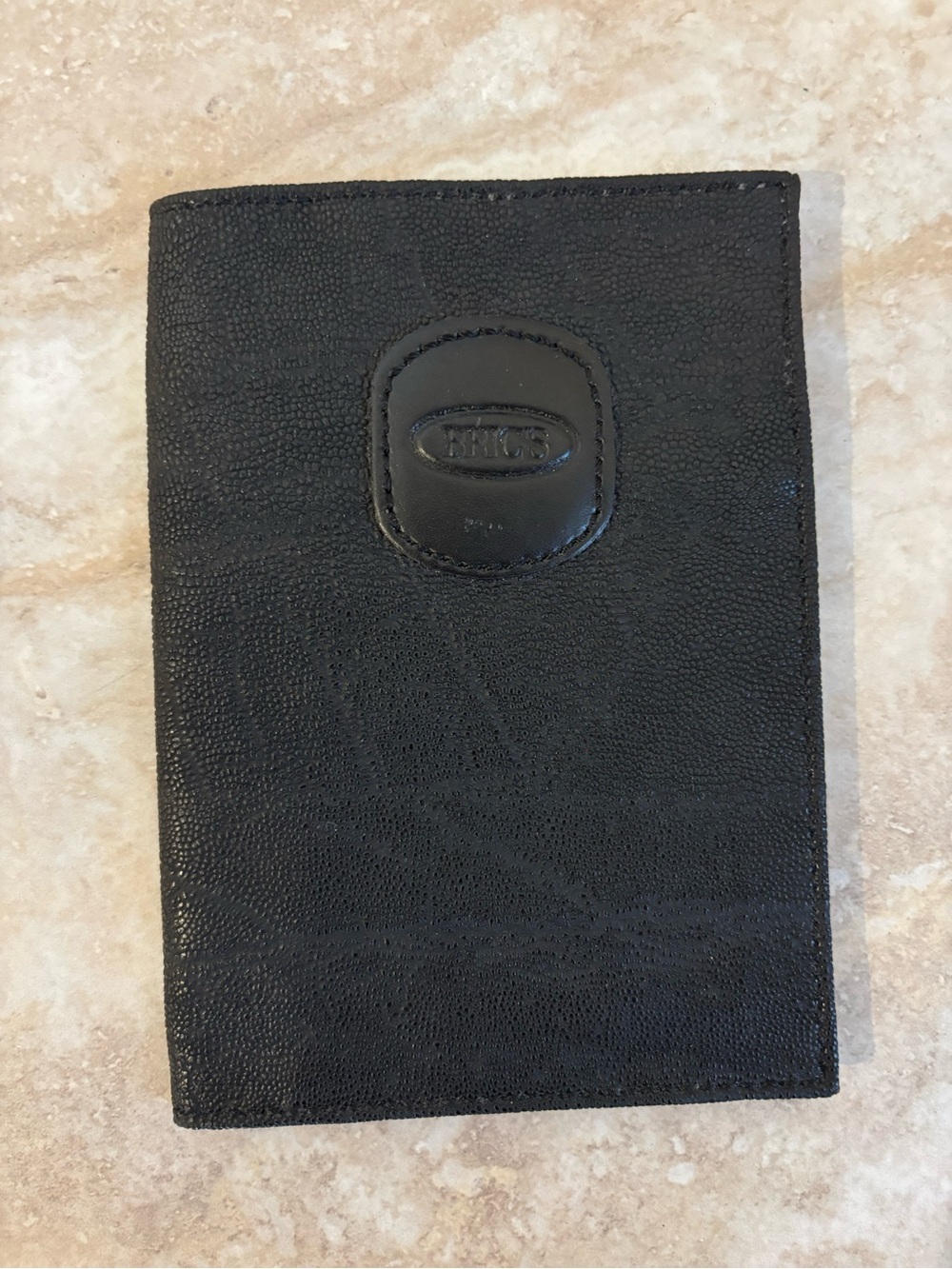 Bric’s Black Textured Passport Holder with Embossed Logo